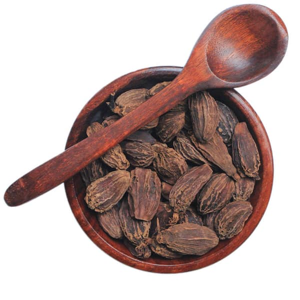 Black Cardamom in a wooden bowl with wooden spoon